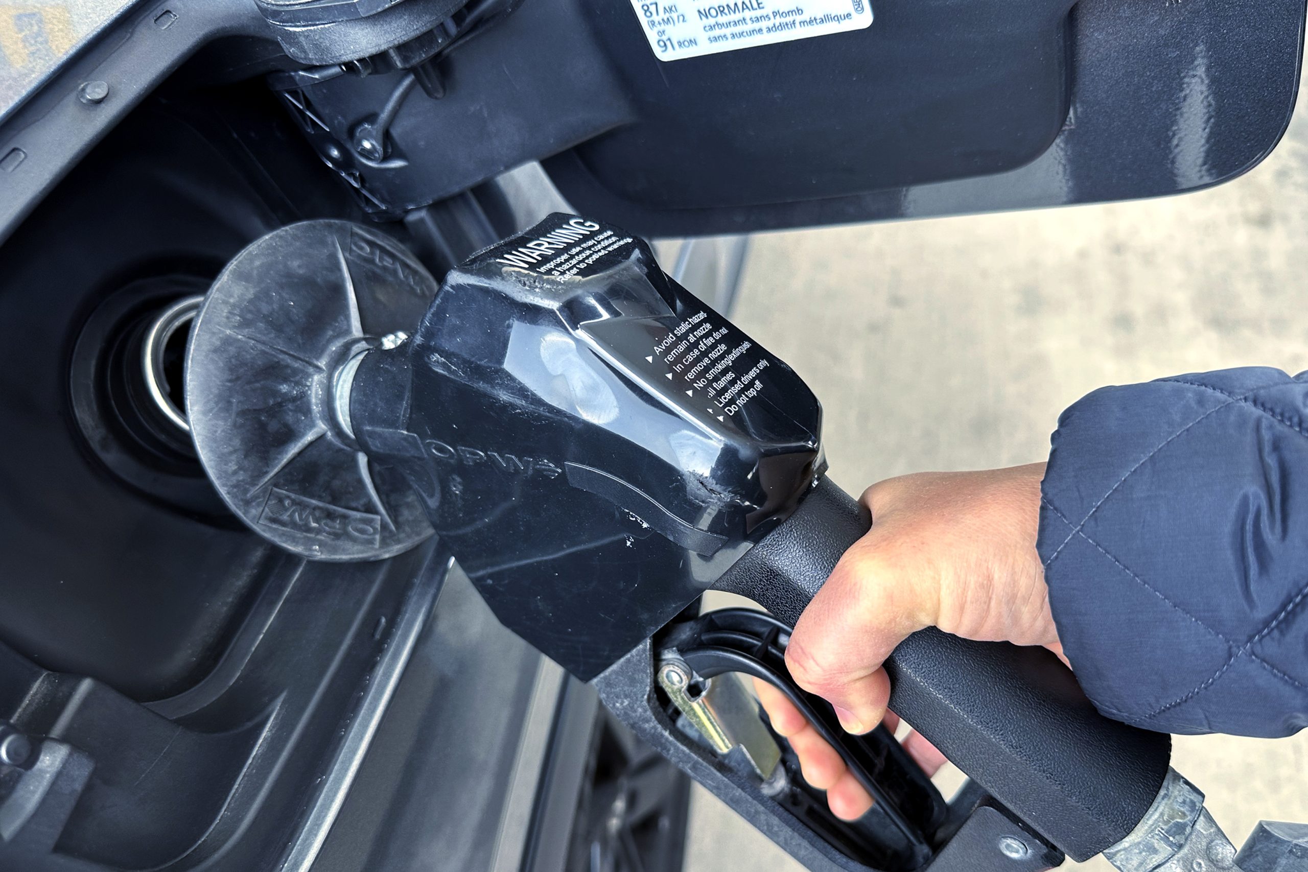 A customer pumps gas at a gas station.