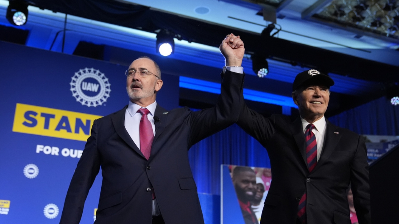 President Joe Biden stands with Shawn Fain, President of the United Auto Workers.