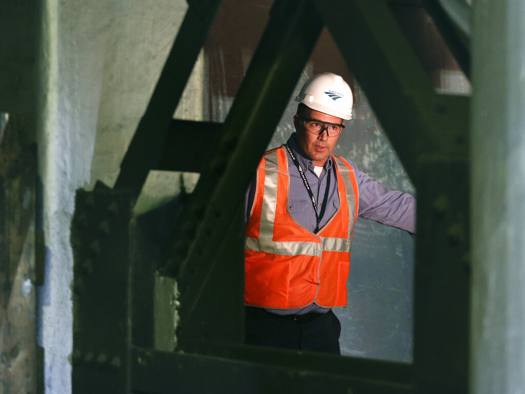 A train engineer oversees train troubles