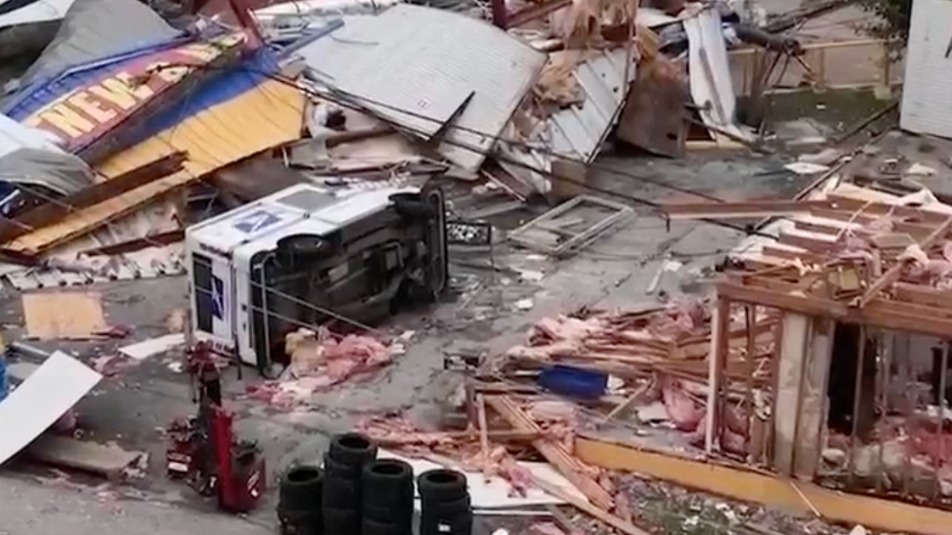 Aerial view of damages from deadly storms in Houston shows debris, damaged buildings and an overturned mail truck