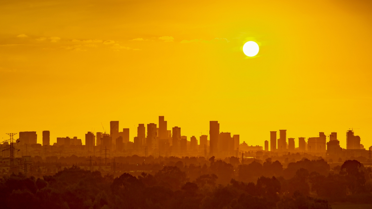 The sun over a city skyline