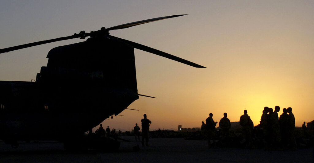 U.S. troops wait to board a helicopter