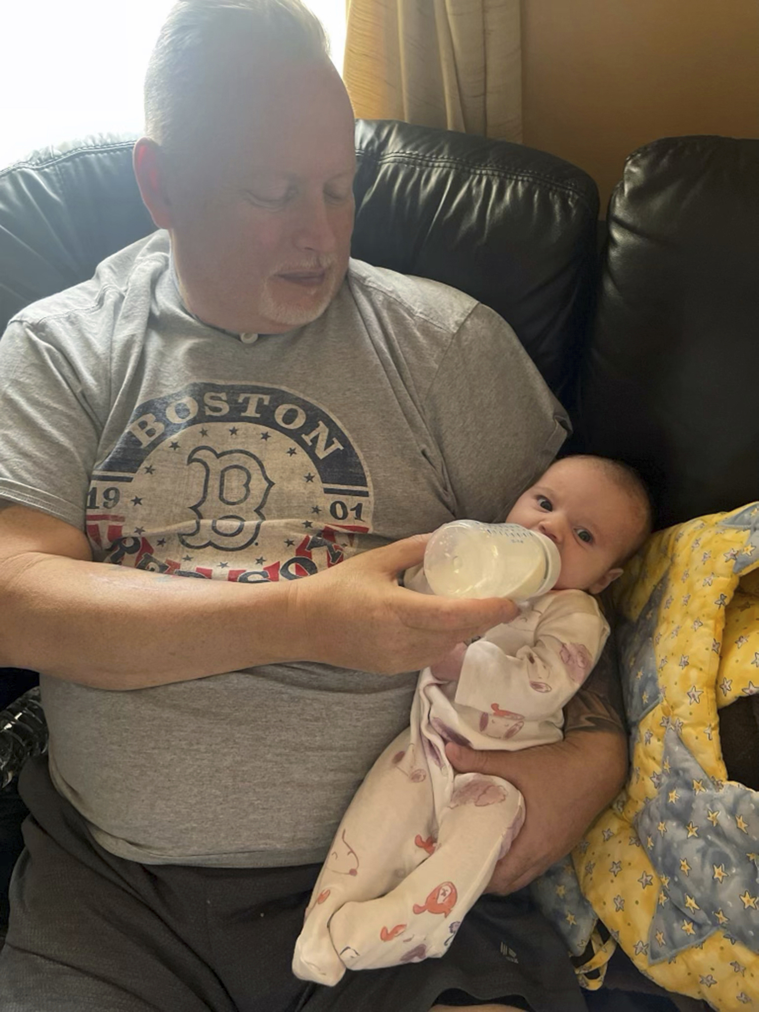 In this photo provided by the family, Marty Kedian holds his granddaughter.
