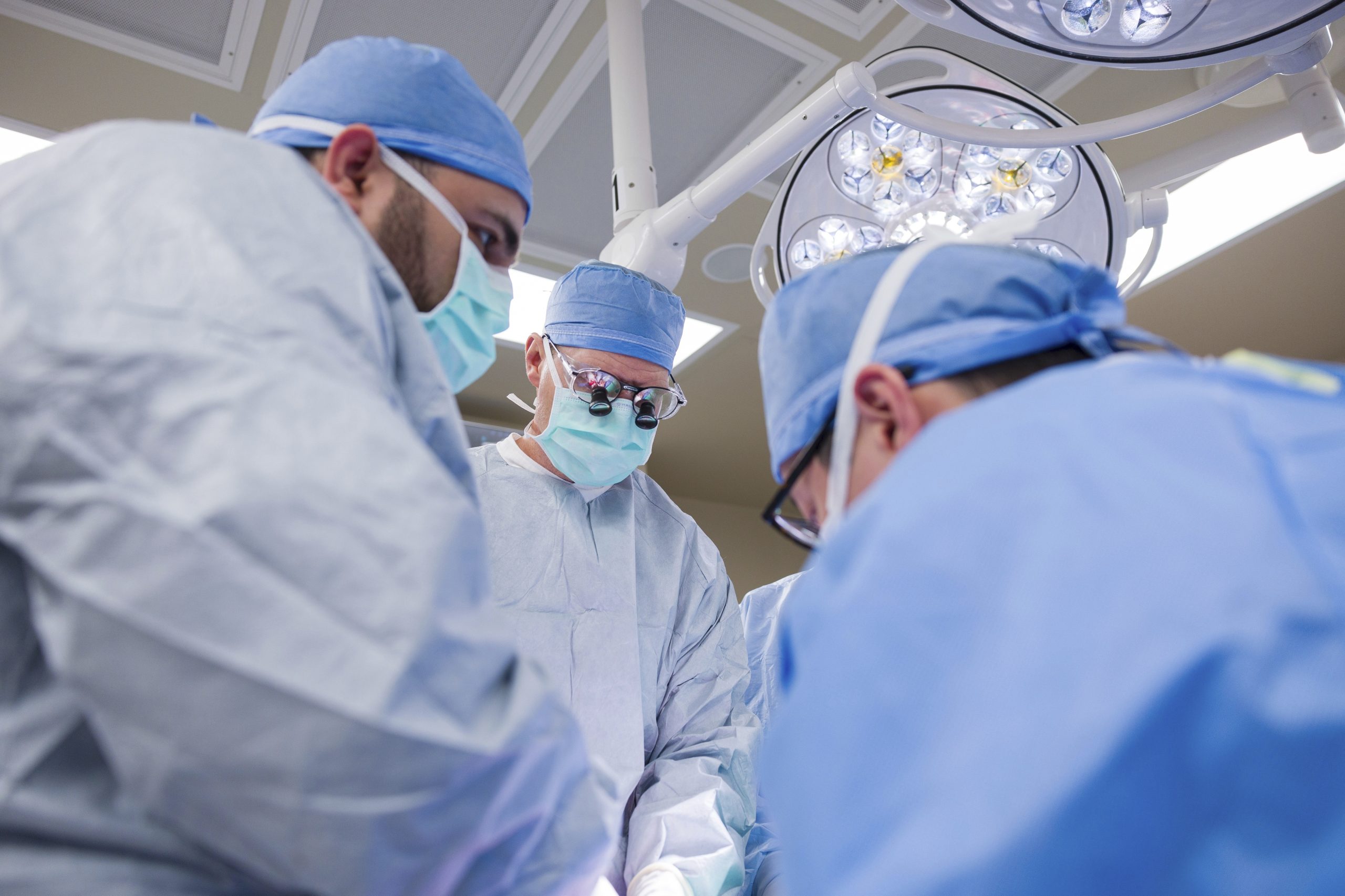 In this photo provided by the Mayo Clinic, Dr. David Lott, surrounded by multi-disciplinary team of doctors, operates on Marty Kedian.