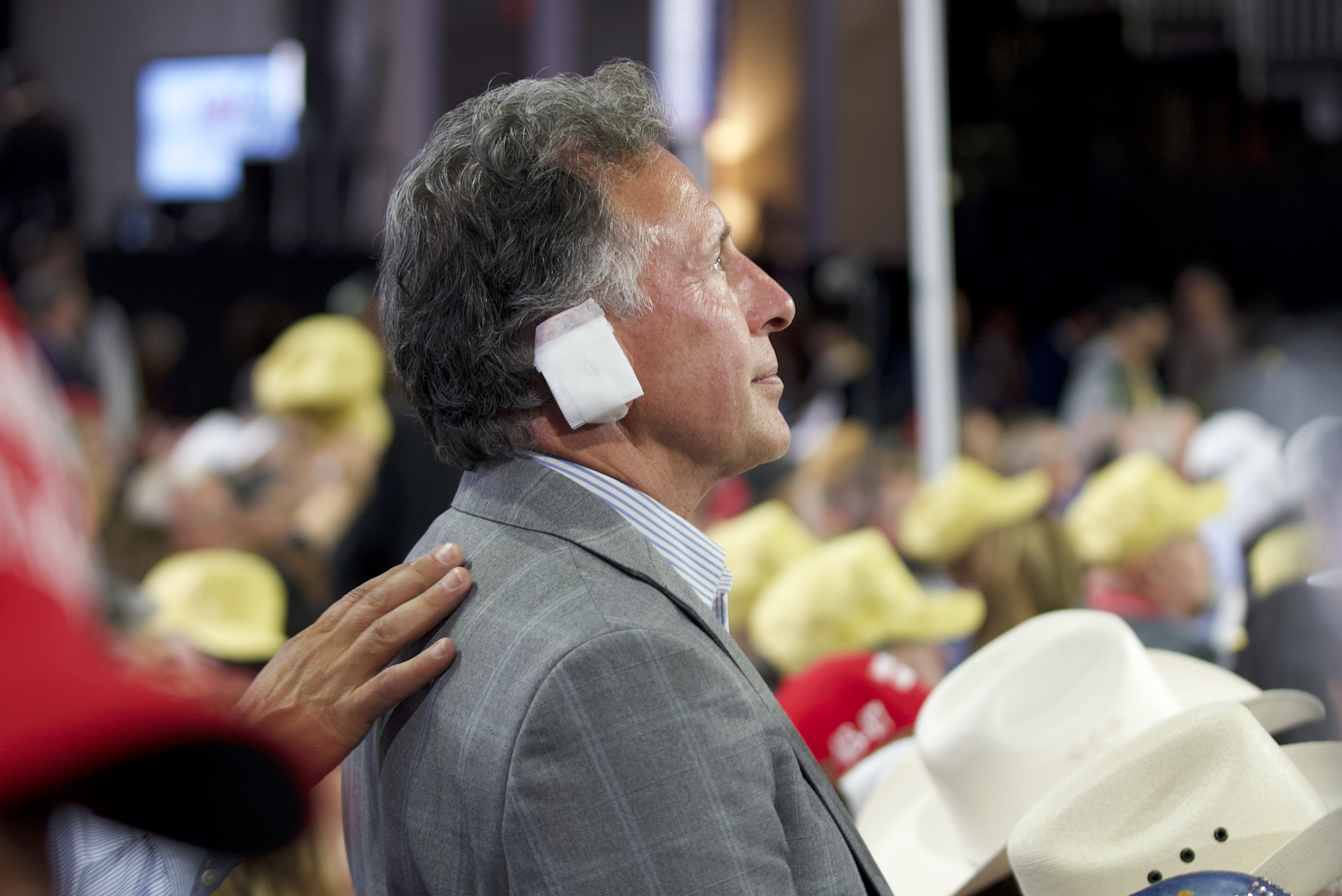 RNC attendee wears a bandage over his ear to show solidarity with Trump.