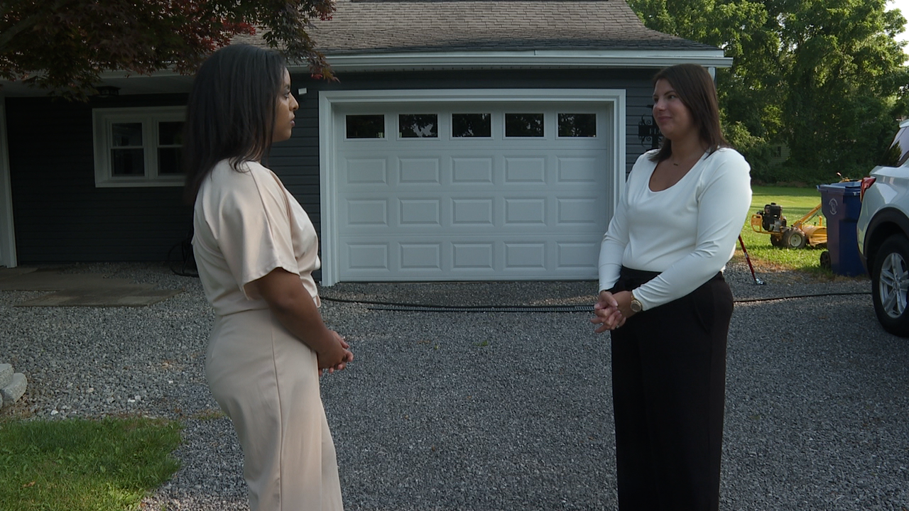 Scripps News Buffalo's Pheben Kassahun, left, speaks with Sanborn mother Tiffany Floyd outside of her home.