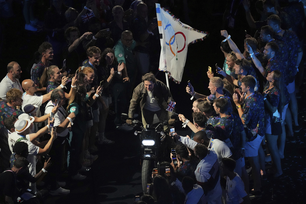 Tom Cruise rides a motorbike during the 2024 Summer Olympics closing ceremony at the Stade de France.