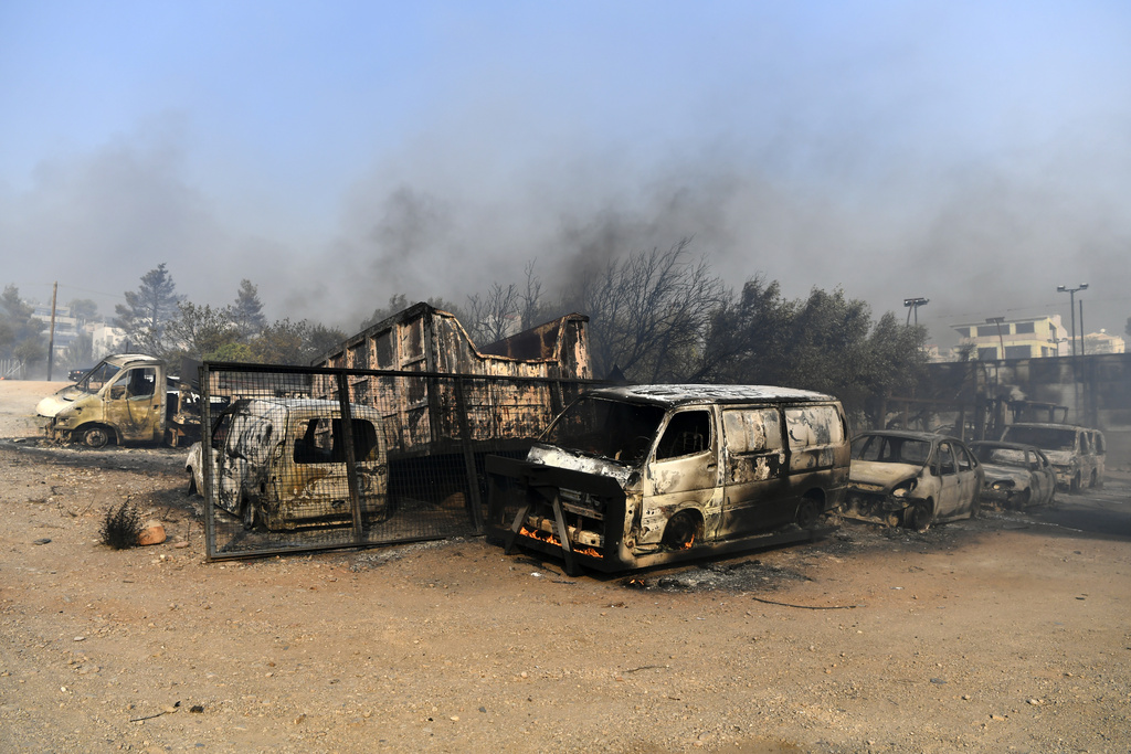 Vehicles burned in a major wildfire in Greece.