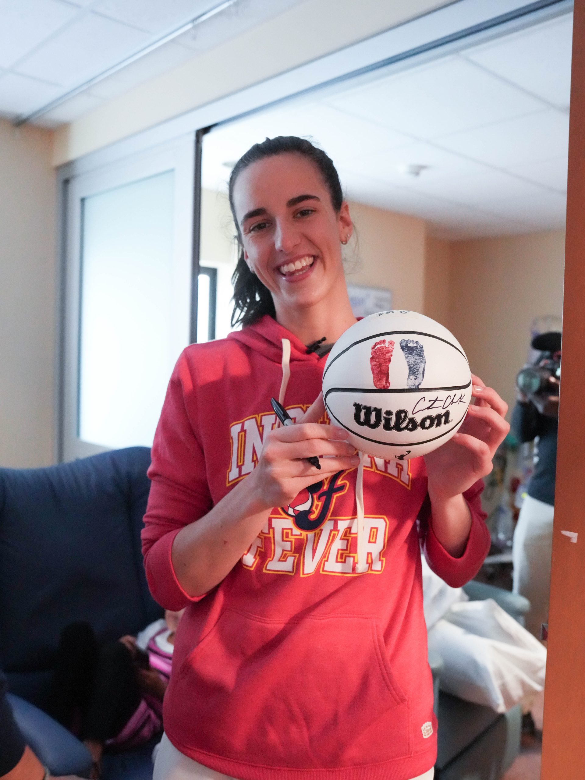 Caitlin with baby feet ball.jpg