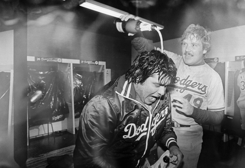 Los Angeles Dodgers pitcher Fernando Valenzuela is doused with champagne by teammate Tom Niedenfuer after the Dodgers won the National League title over the Expos, Oct. 20, 1981, in Montreal.