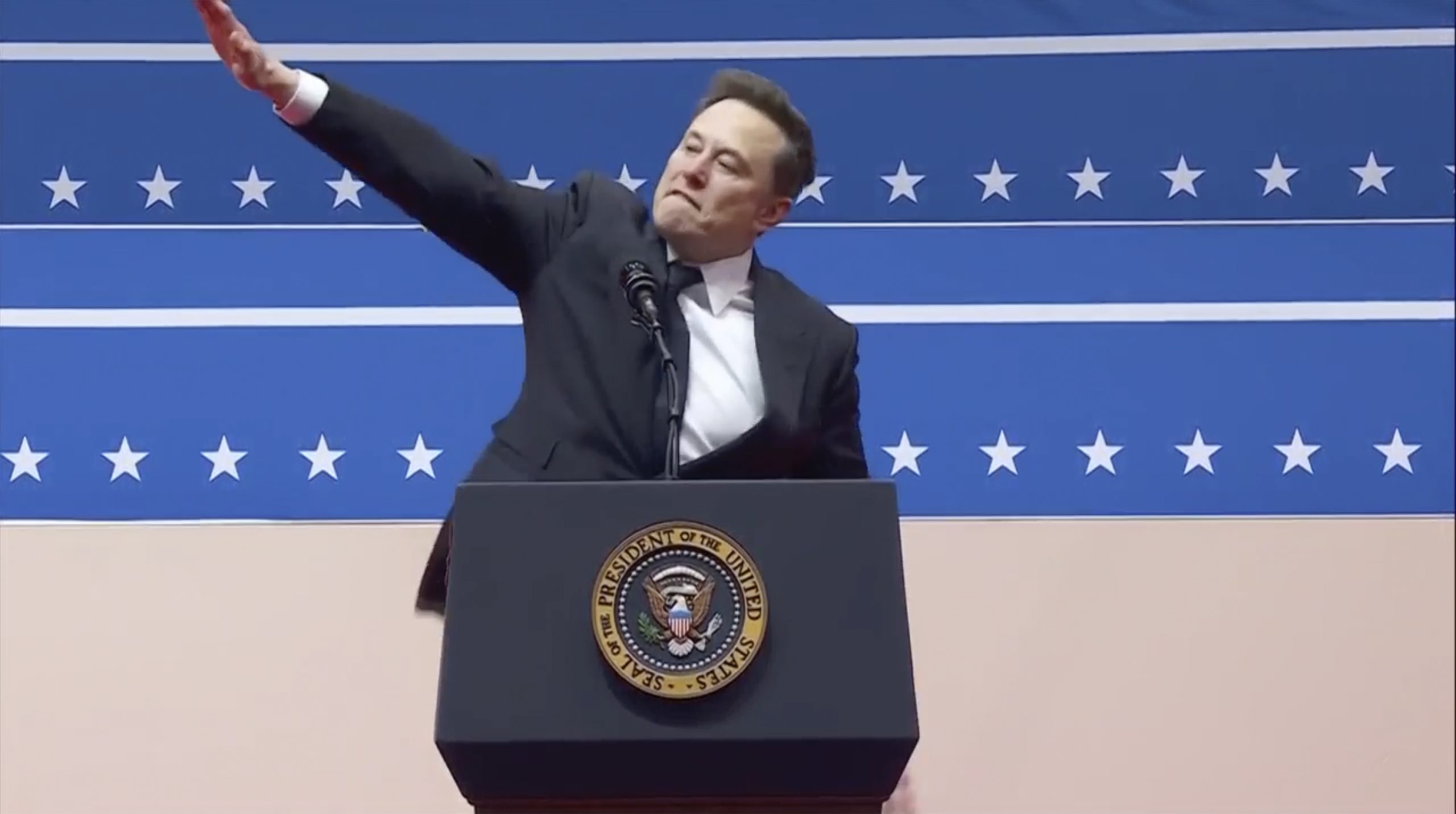Elon Musk gestures while speaking at an indoor Presidential Inauguration parade event in Washington.