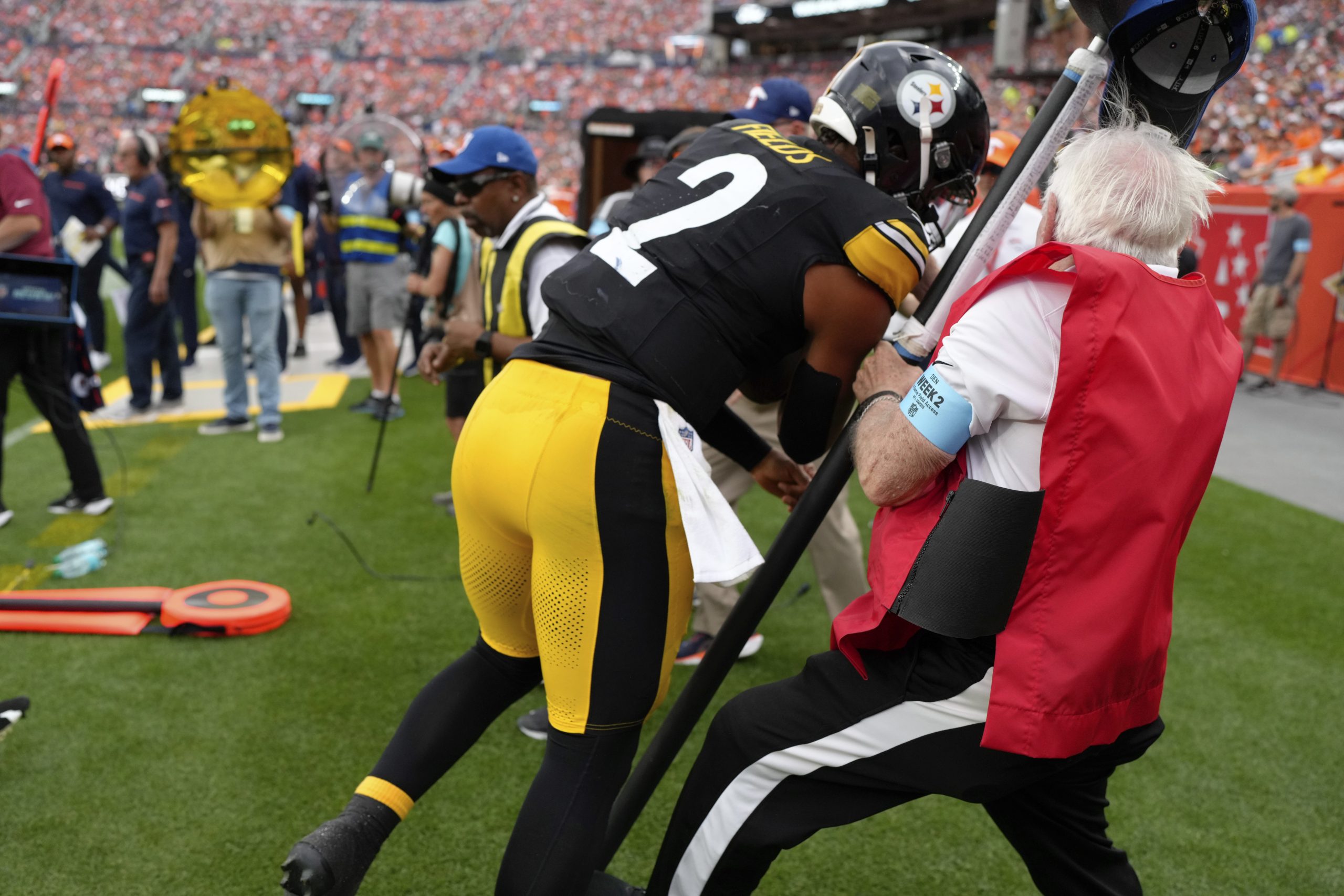 Pittsburgh Steelers quarterback Justin Fields (2) collides with a chain crew on the sideline during the second half of an NFL football game against the Denver Broncos, Sunday, Sept. 15, 2024, in Denver. 