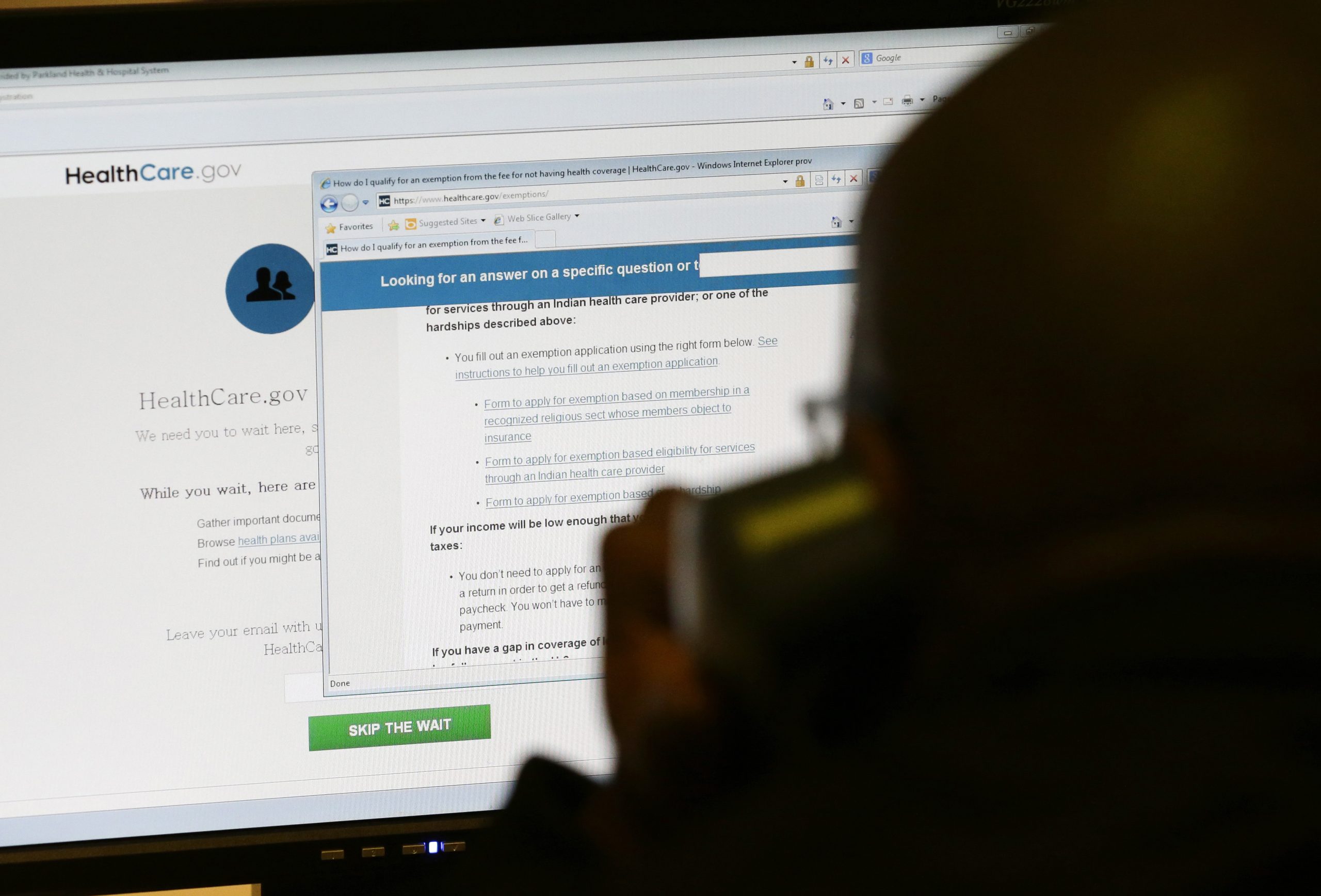 A person looks at the healthcare.gov webpage