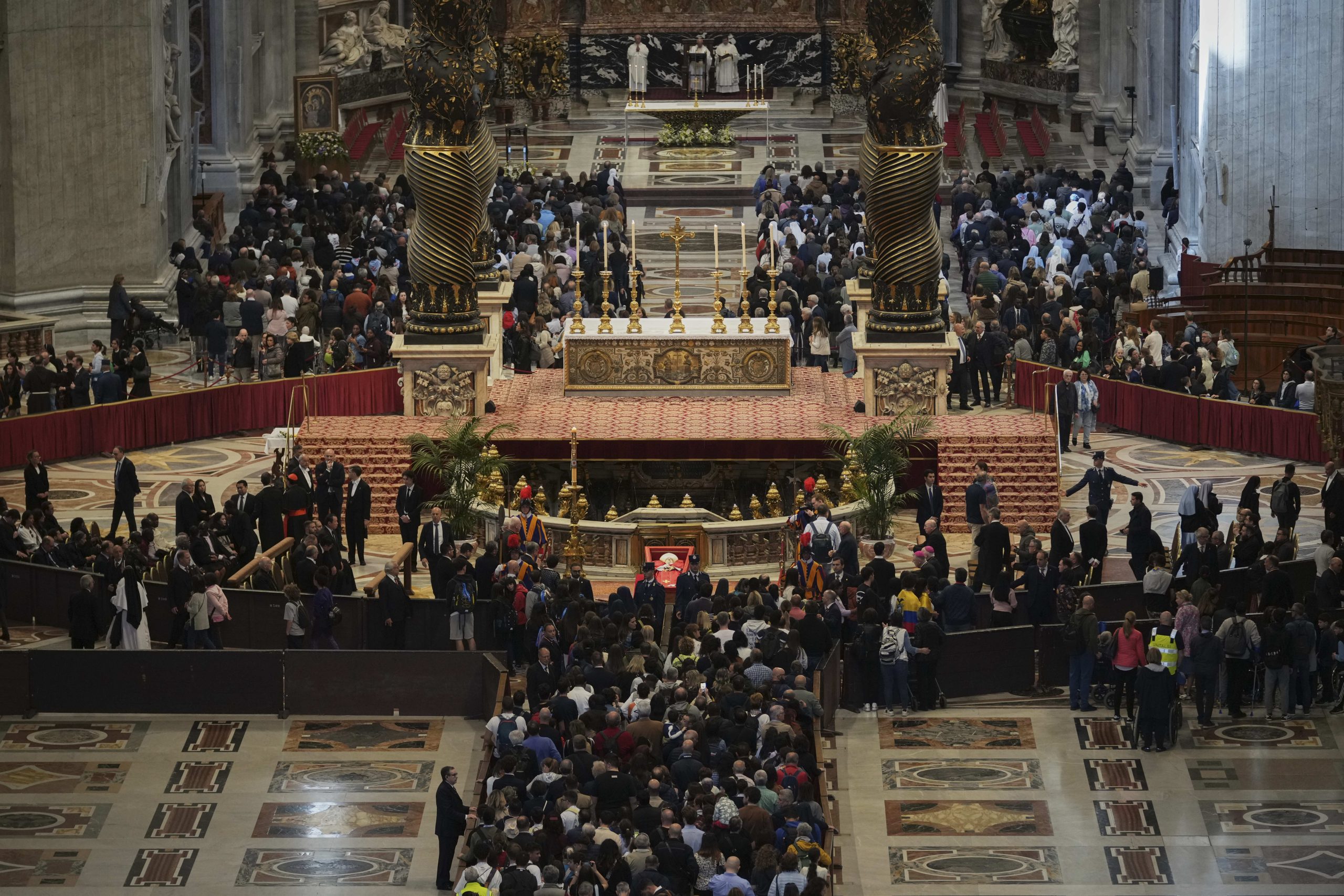 People line up to pay their respects to Pope Francis lying in state, inside St. Peter's Basilica, at the Vatican, Friday, April 25, 2025. 