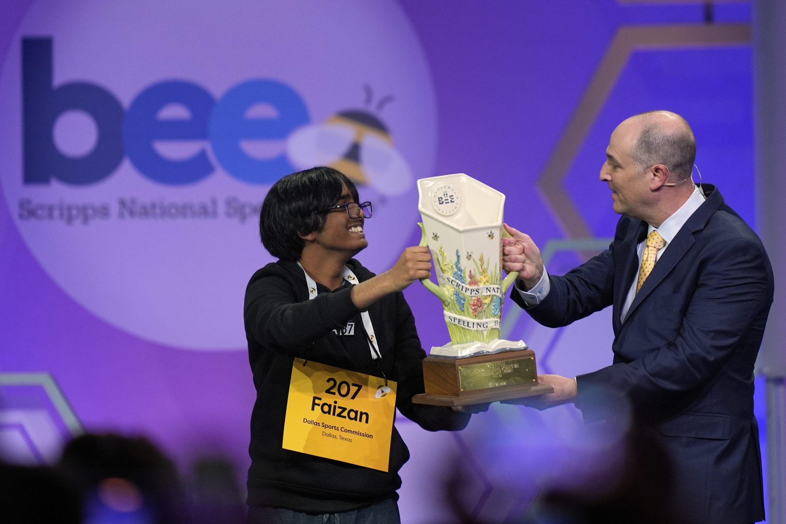E.W. Scripps Company president and CEO Adam Symson presents the trophy to Faizan Zaki, 13, of Dallas, the winner of the 2025 Scripps National Spelling Bee, Thursday, May 29, 2025, in Oxon Hill, Md.