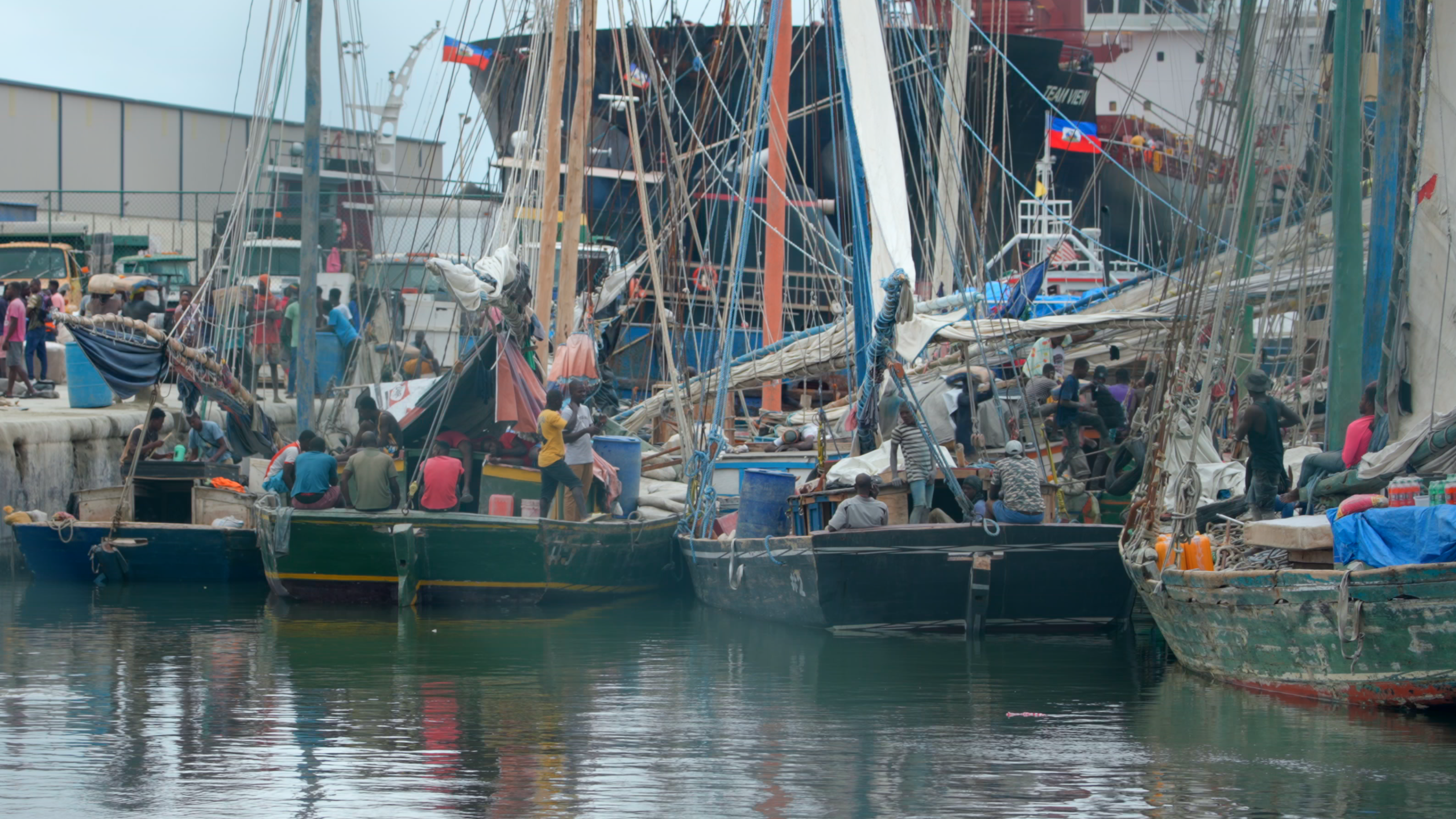 Workers load food onto small fishing boats in Cap-Haïtien’s port.