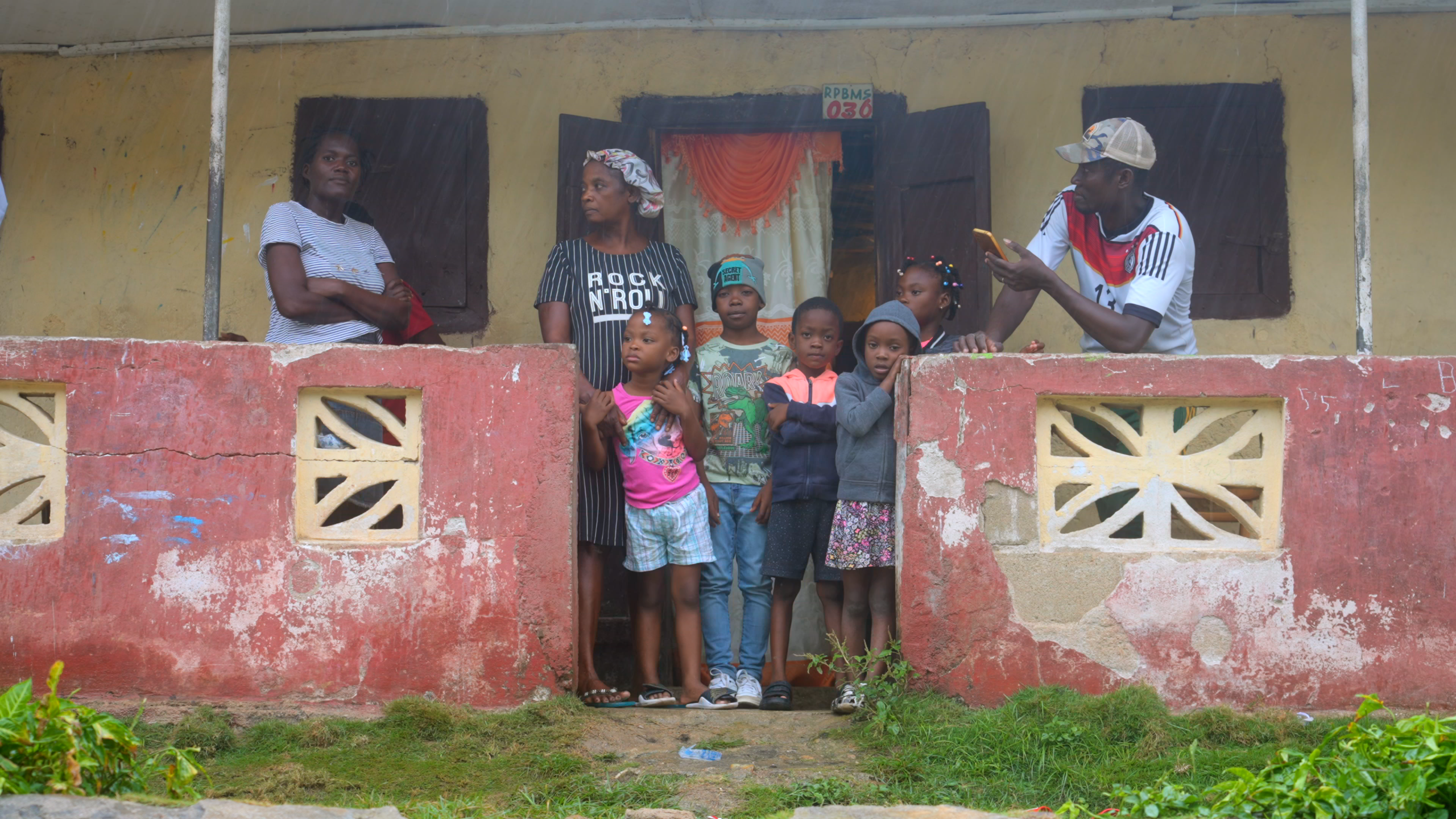A family in front of their home in Haiti.