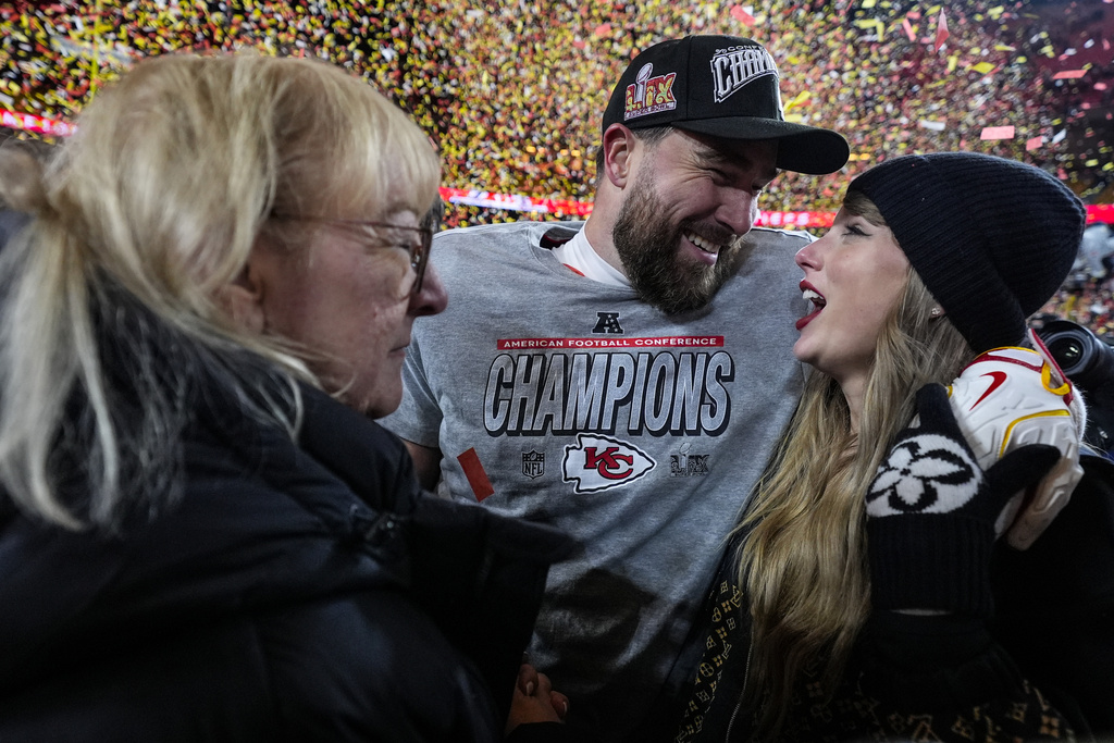 Donna Kelce stands with her son, Kansas City Chiefs tight end Travis Kelce, and Taylor Swift after the AFC Championship NFL football game against the Buffalo Bills, Sunday, Jan. 26, 2025, in Kansas City, Mo.