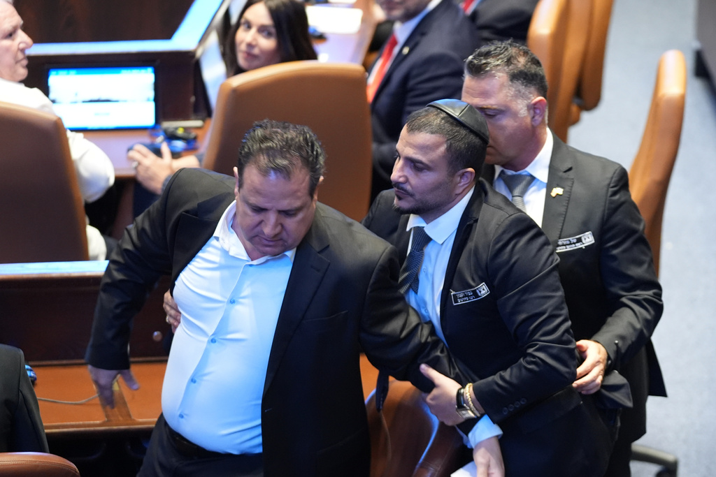 Security officials remove a Knesset member who interrupted President Donald Trump speech to the Knesset, Israel's parliament, Monday, Oct. 13, 2025, in Jerusalem. 