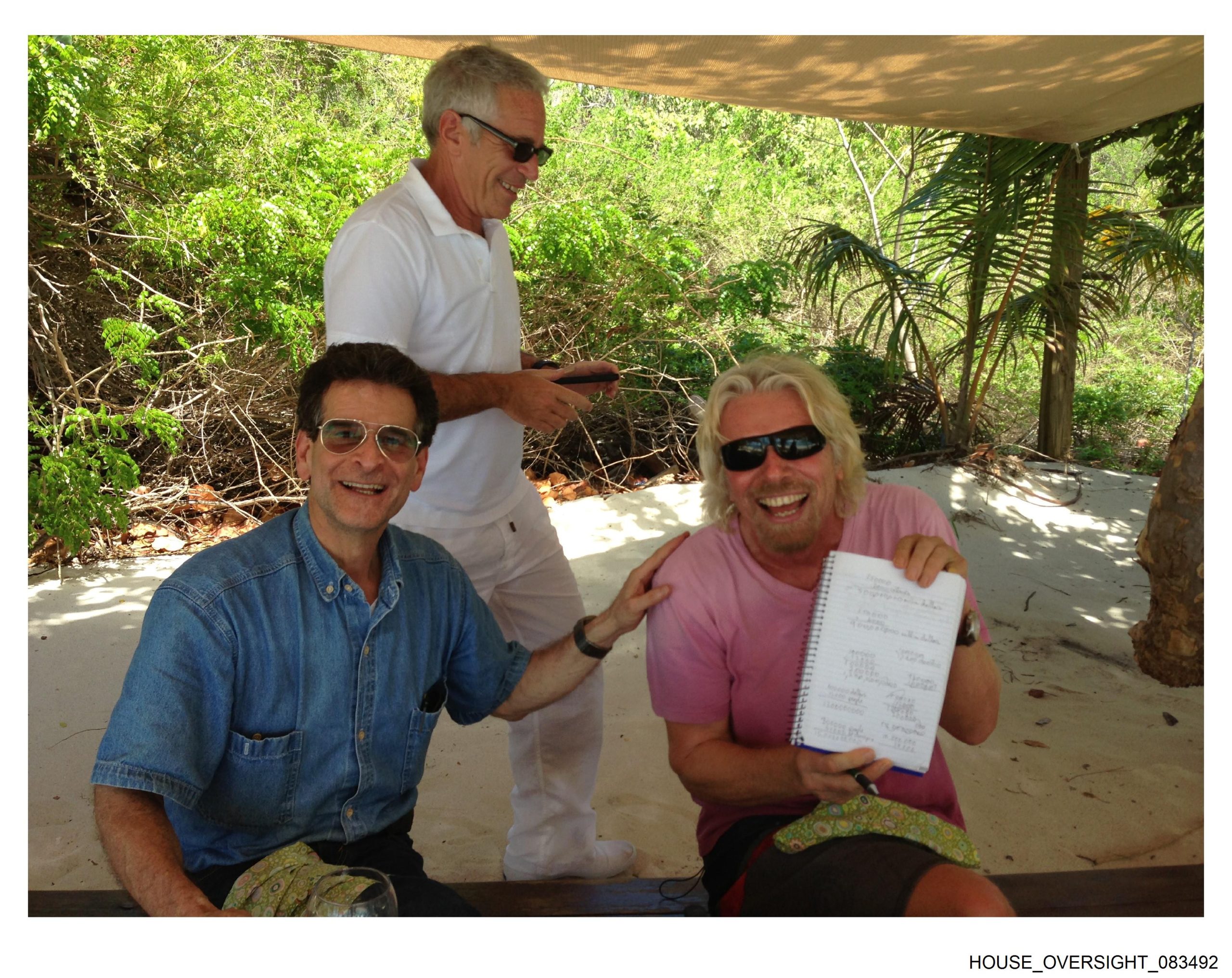 Sir Richard Branson appears with Jeffrey Epstein and another man.