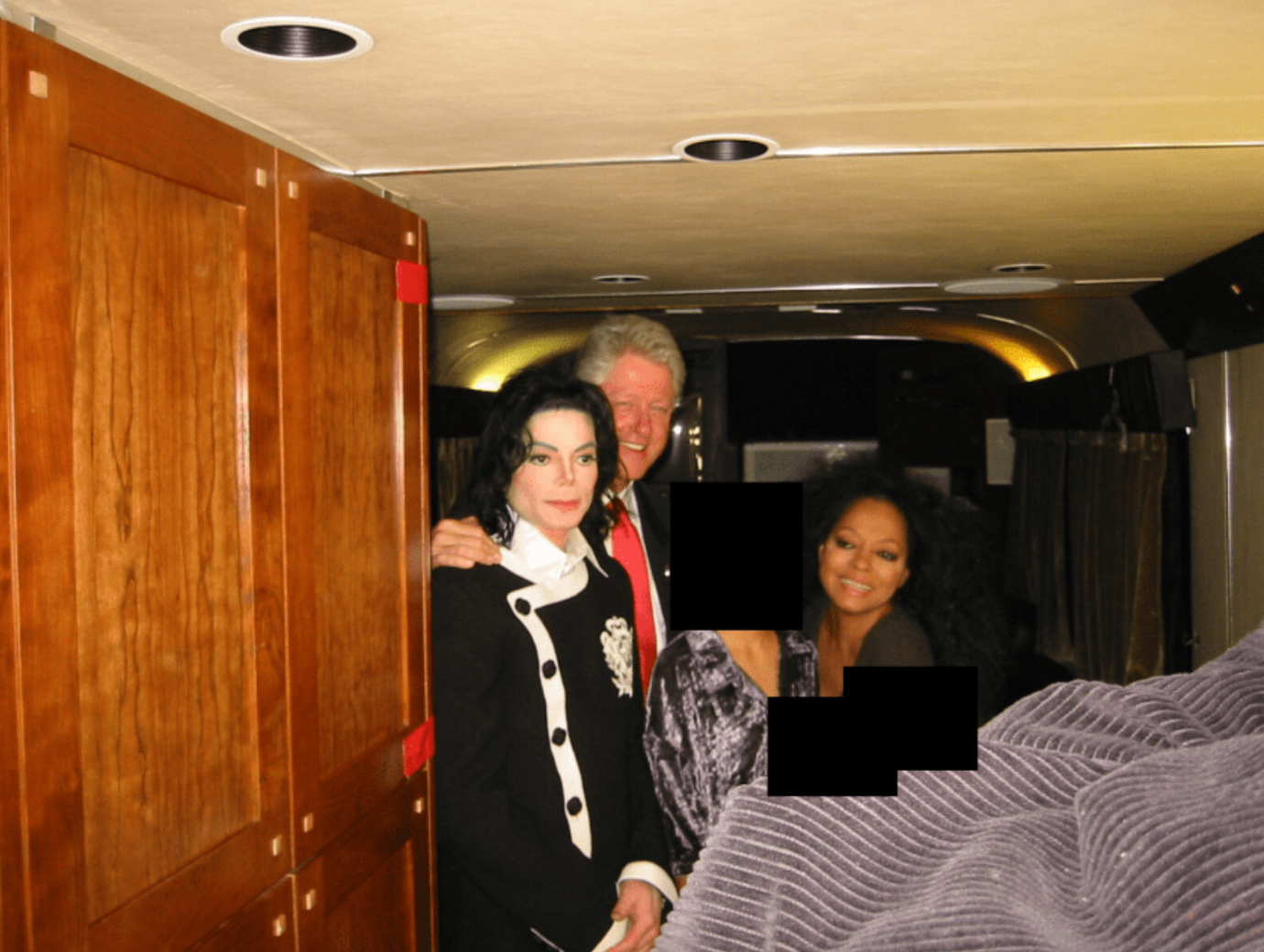 Former President Bill Clinton and what appears to be Michael Jackson and Diana Ross.