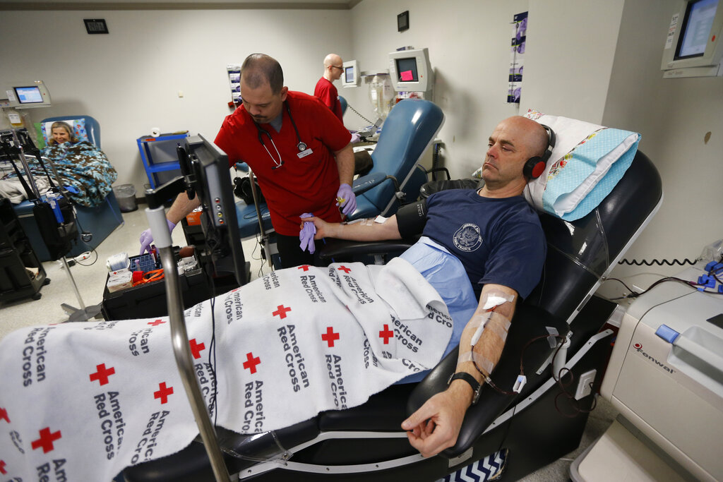 A man gives blood at the American Red Cross Donation Center in Murray, Utah.