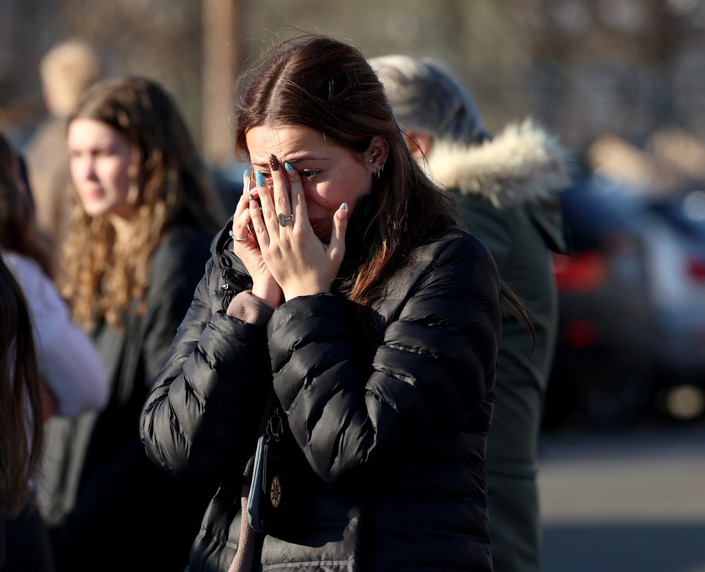 A woman reacts near the Lynch Arena in Pawtucket, R.I., after a shooting at the ice rink, Monday, Feb. 16, 2026.
